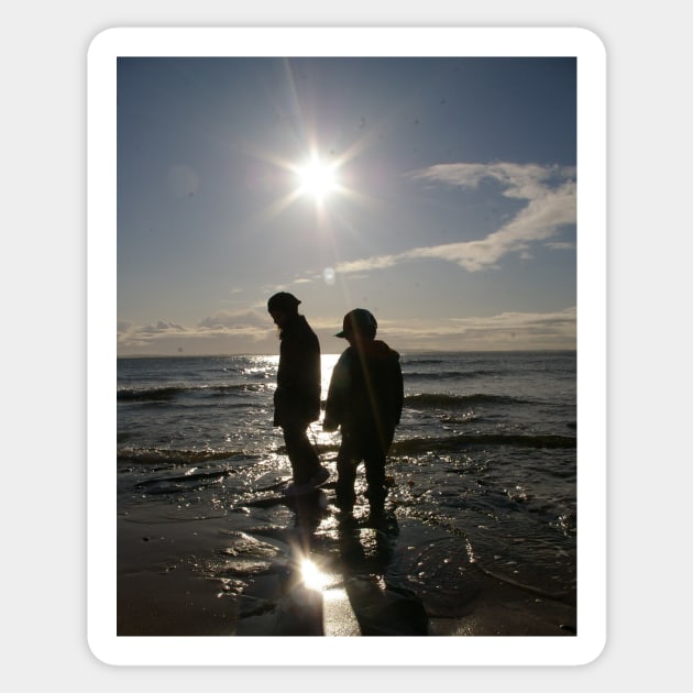 Children Silhouetted On A Beach Sticker by archiesgirl